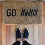 Doormat that reads “Go Away” placeholder